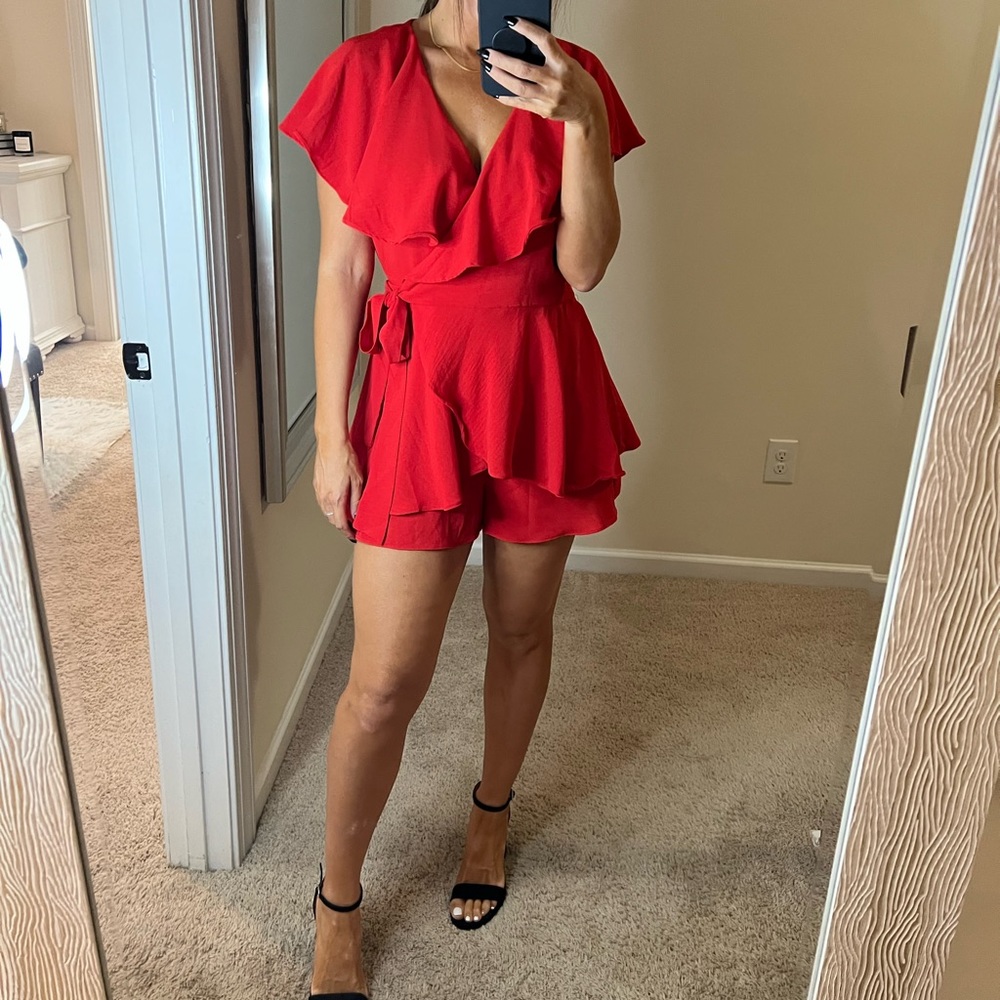 The cutest red romper. From Boutique Vestique new with tag size Medium.